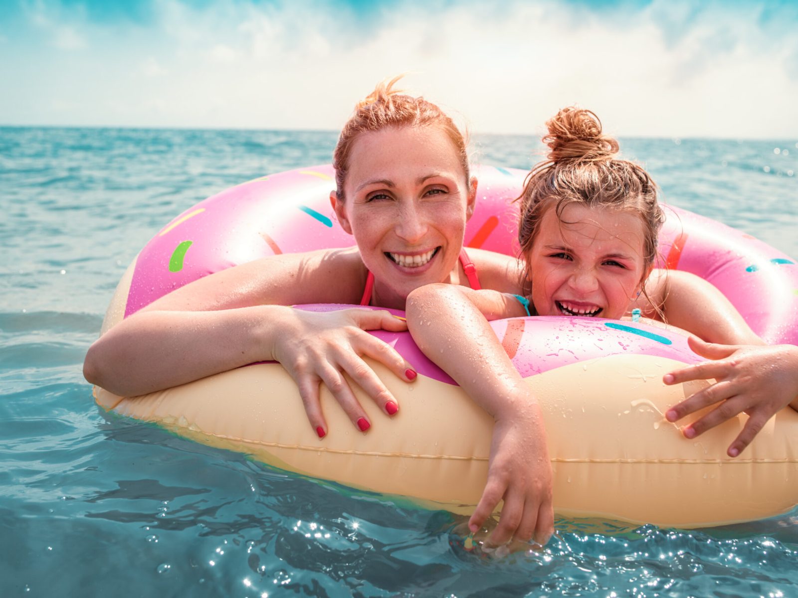 happy mother with daughter in the sea